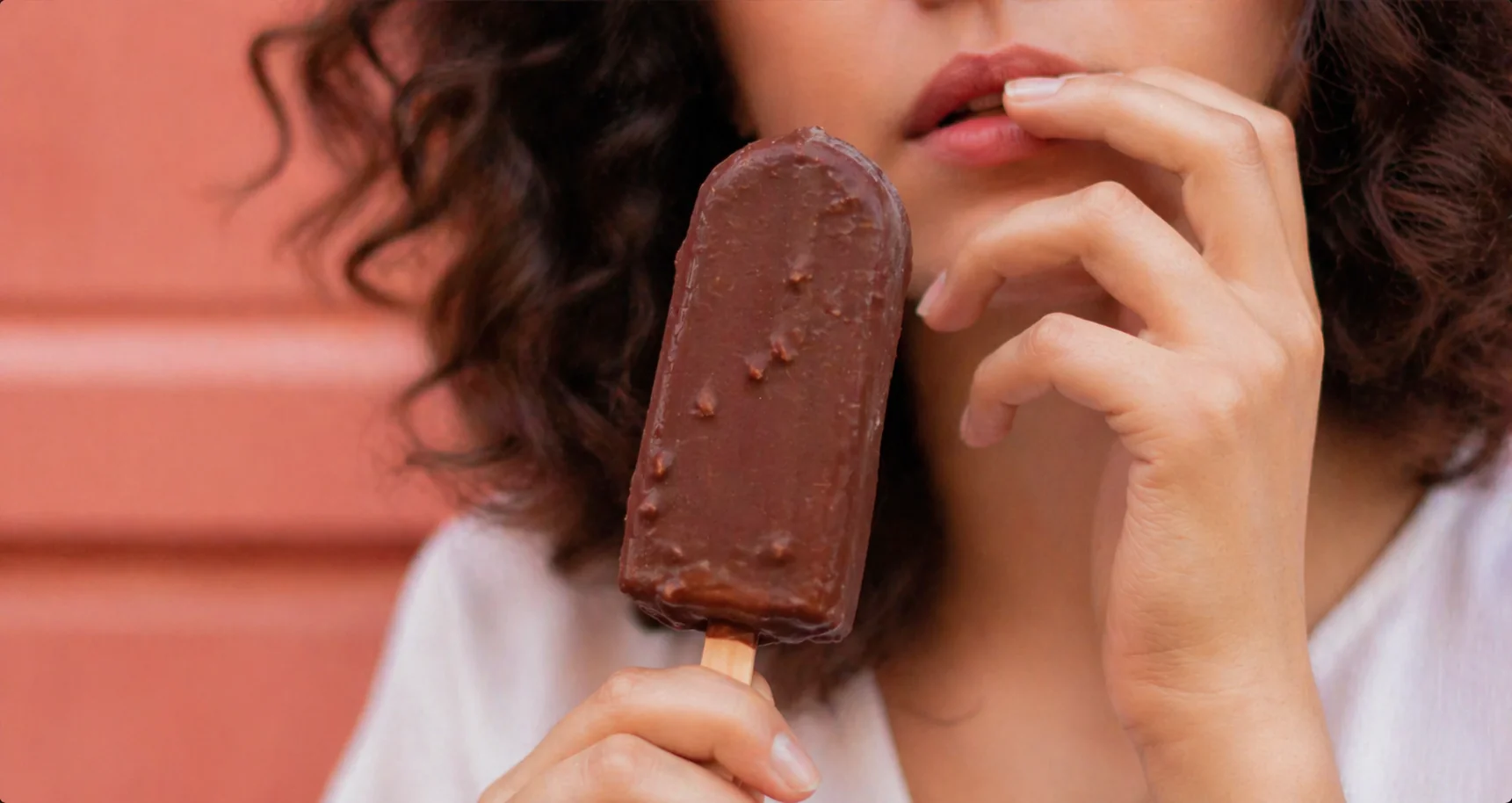 Close up of chocolate ice cream against terracotta wall
